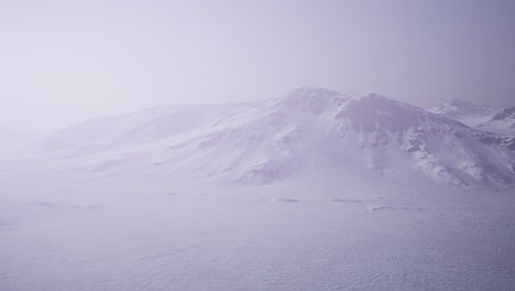 Aerial-Landscape-of-snowy-mountains-and-icy-shores-in-Antarctica